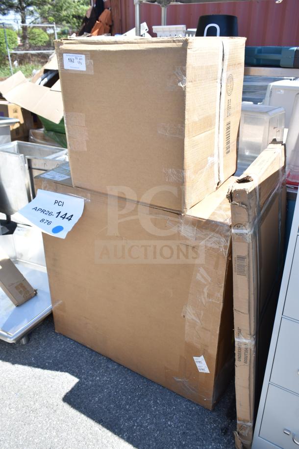 Three sealed boxes containing scratch and dent items, including a dish table and work table, labeled "APR26-144."