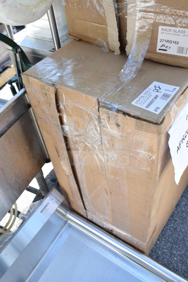 Three brand new "scratch and dent" items, including a dish table and work table, in sealed cardboard boxes with visible labels.