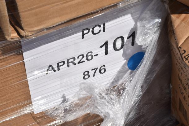 Cardboard boxes with labels reading "PCI APR26-101, 876" and plastic wrap, indicating auctioned scratch and dent items.