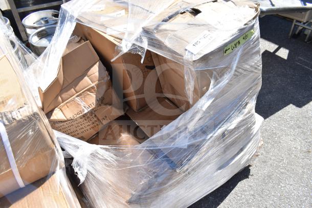 Pallet with boxes of new scratch and dent items, wrapped in plastic. Visible labels show product details like UPC code.