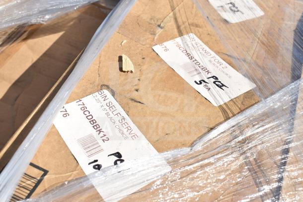 Pallet of new scratch and dent items with visible labels for bin self-serve and stand, wrapped in plastic.