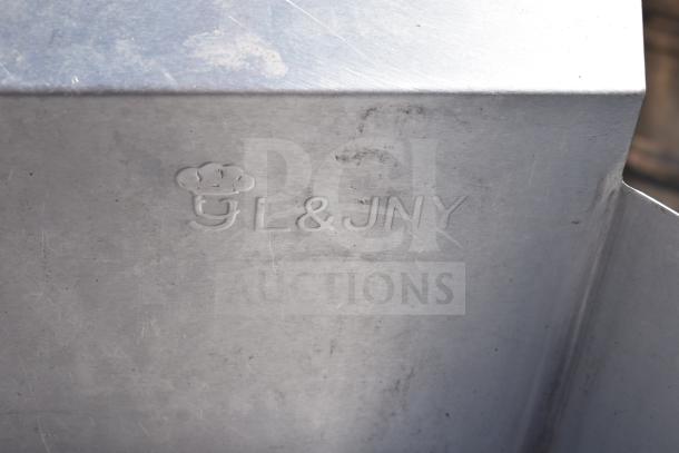 Alt text: Stainless steel dish table marked "GL & JNY," showing surface wear. Includes clean and dirty side tables.