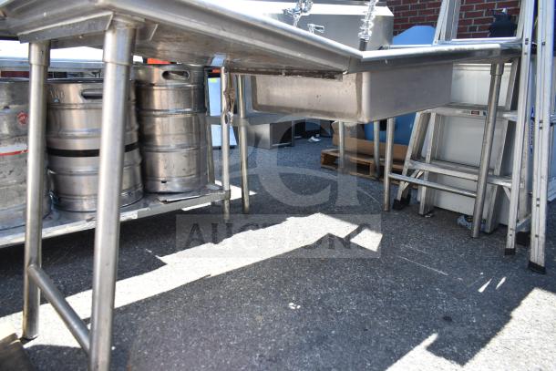 Stainless steel clean and dirty side dish tables, durable construction, includes visible kegs under clean side. Auction item.