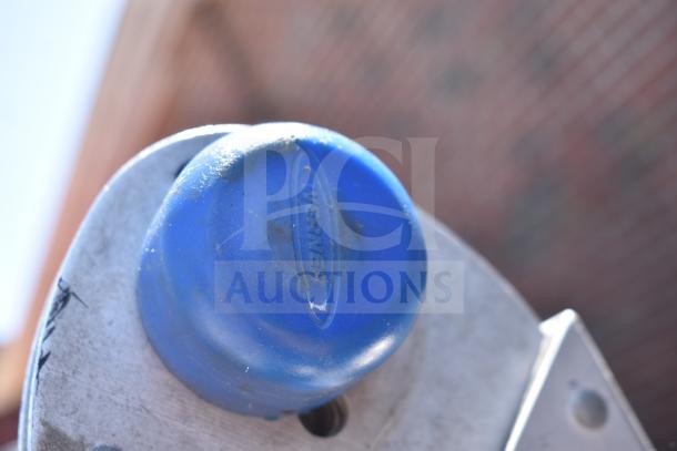 Close-up of a Werner ladder cap featuring blue rubber and visible logo. Slight wear indicates pre-owned condition.