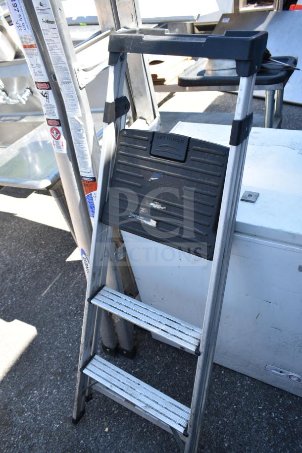 Two aluminum step ladders, Cosco brand, foldable, sturdy, with visible safety labels. Good condition, ideal for home use.