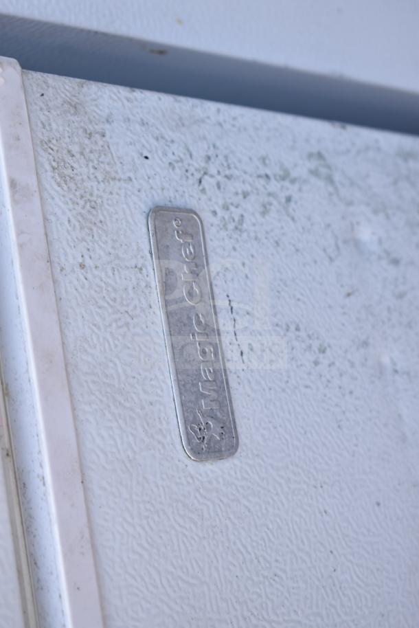 2 Magic Chef HMCF5W4 chest freezers, white, 115 volts, 1 phase. Visible Magic Chef logo. Used condition. Total of 2 units.