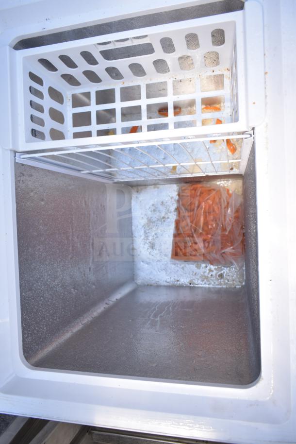 Magic Chef HMCF5W4 chest freezer interior with wire basket, minor frost. 115 volts, 1 phase. Auction: 2 units available.