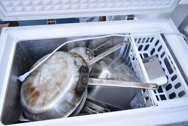 Magic Chef HMCF5W4 chest freezer with cookware inside. 115V, 1 phase. Includes white basket. Used condition.