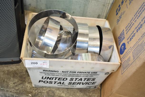 Box of 12 round metal collars in a USPS crate, polished finish, good condition. Quantity x12 label visible.