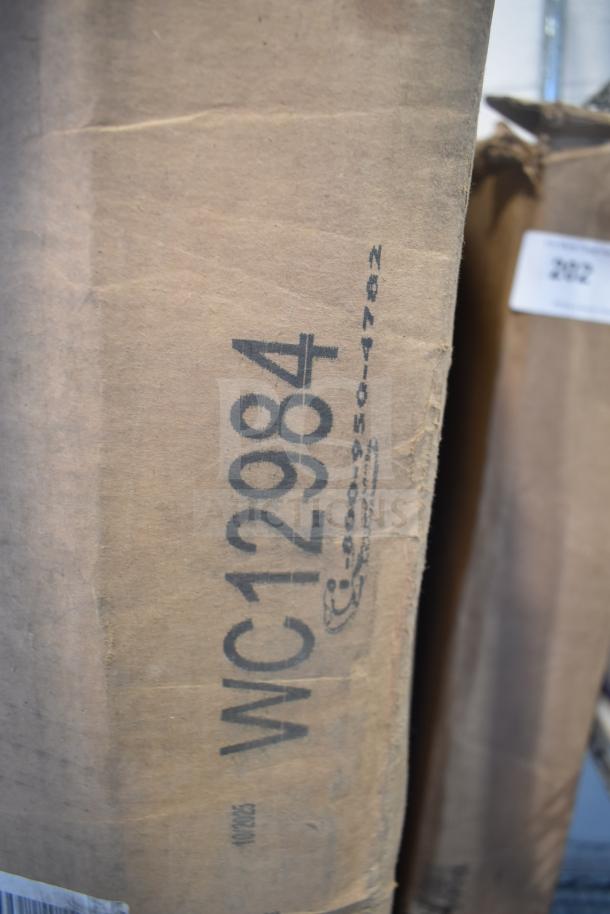 Brown shipping box labeled "WC12984." Contains a brand new, scratch and dent 42W x 24D sit-to-stand desk return.