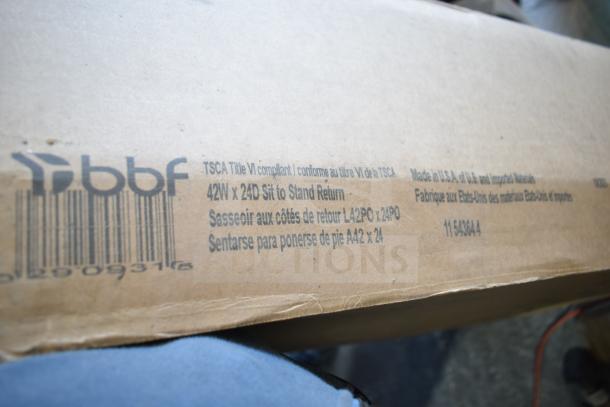 Alt text: Box with "bbf 42W x 24D Sit to Stand Return" label, TSCA Title VI compliant, made in USA, item WC12984.