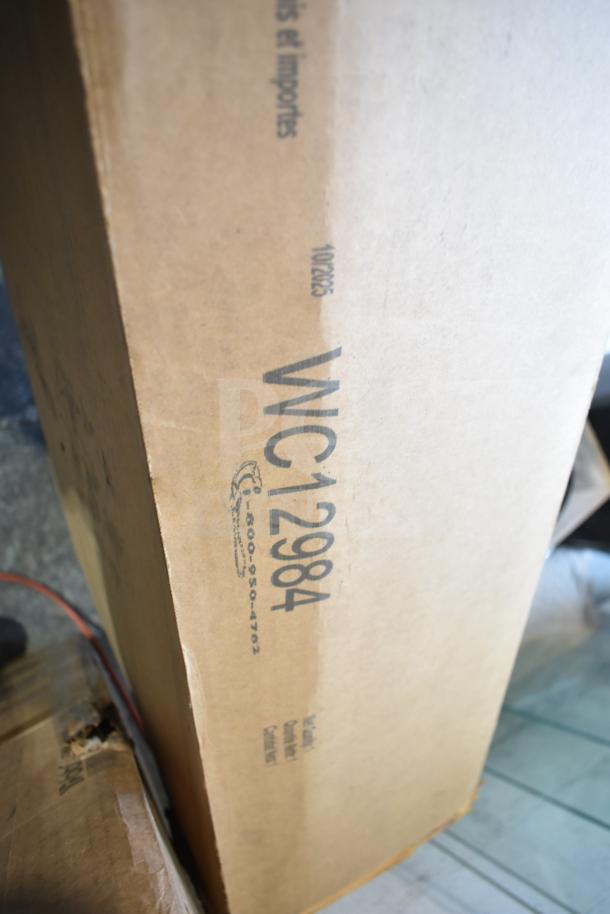 Cardboard box labeled "WC12984" with dimensions 42W x 24D. Item is a brand new scratch and dent Sti to Stand Return.