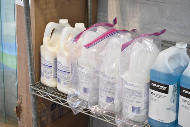 Three-tier lot with Coastwide Foaming Hand Soap and Diversey Wiwax ProX Emulsion in various bottles. Shelving not included.