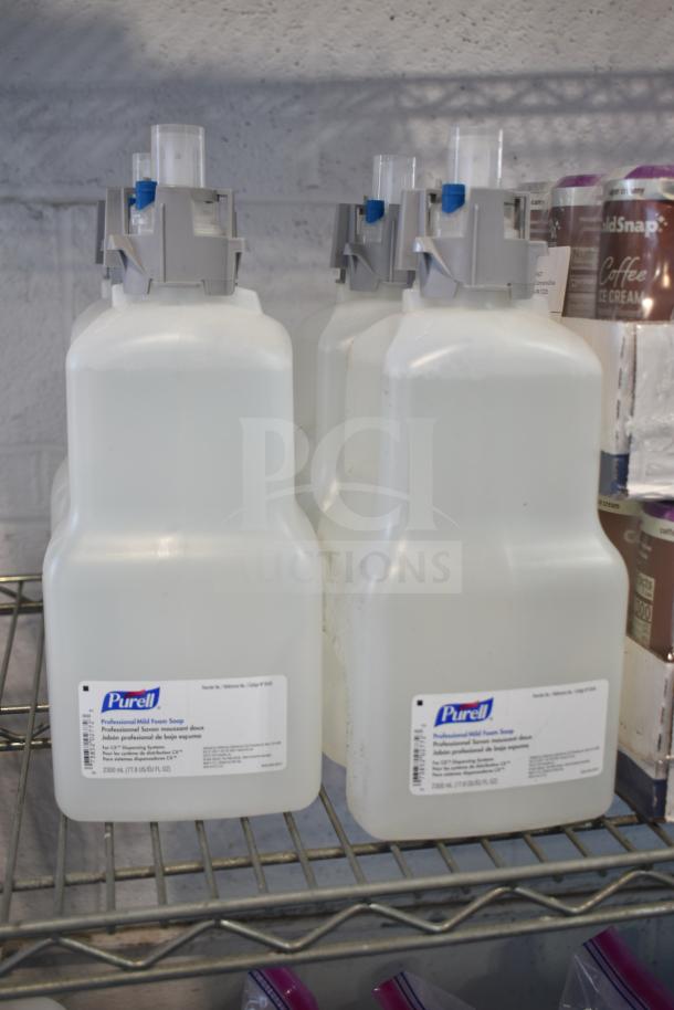 Three Purell Professional Mild Foam Soap bottles on a metal shelf, 2300 mL each, with labeled dispensers.
