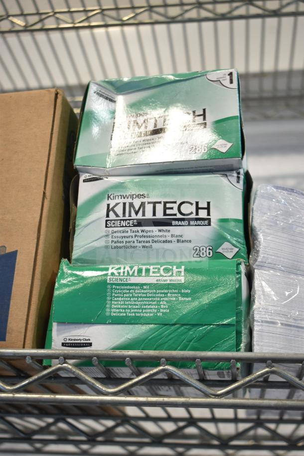 Three boxes of Kimtech Science Kimwipes, delicate task wipes, 286 count each, stacked on a metal shelf.