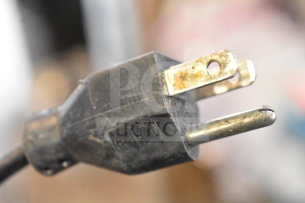 Close-up of a power plug for the Hobart HTi Commercial Food Portioning Scale, operational, 120/208-240V, 1 Phase.