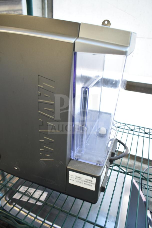 LavAzza 10080632 countertop espresso machine with steam wand, shown in fair condition. Model and serial number labels visible.