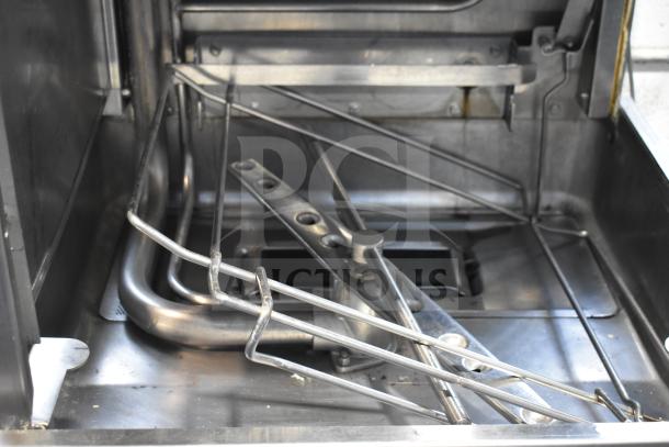 Hobart commercial corner pass-through dishwasher showing stainless steel interior and spray arms, in used condition.