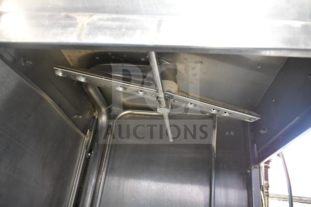 Hobart commercial corner pass-through dishwasher interior view, showing durable stainless steel construction and spray arm.