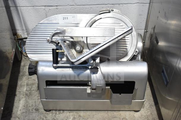 Hobart 1712 Commercial Meat Slicer, 115 Volts, 1 Phase. Stainless steel with manual controls. Slight wear visible.