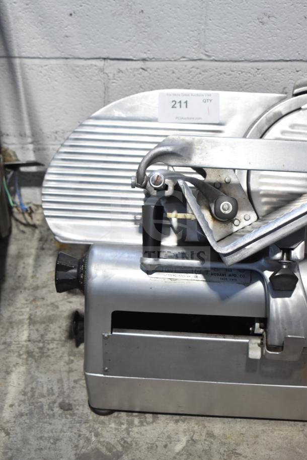 Hobart 1712 commercial meat slicer, 115V, 1 phase, countertop model. Features adjustable slicing thickness and durable metal construction.