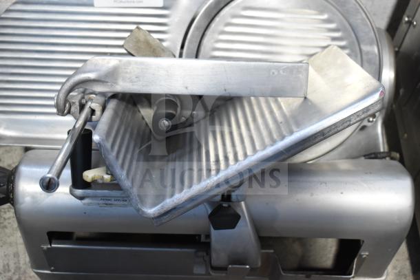 Hobart 1712 commercial meat slicer, 115 volts, with ribbed tray and blade, showing moderate wear, in working condition.