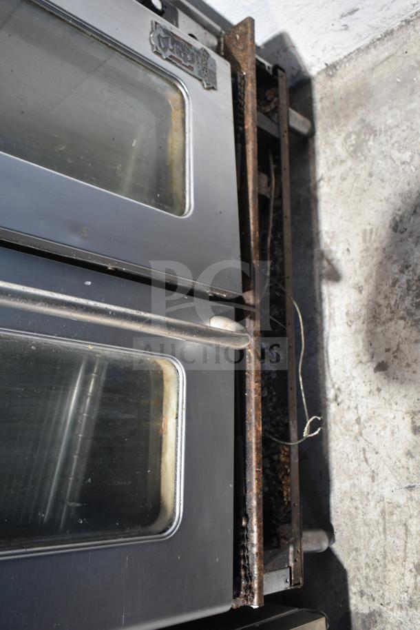 Montague commercial convection oven with view-through doors, thermostatic controls, showing signs of rust on the frame.