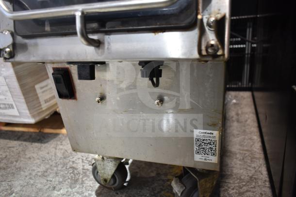 2019 Garland CXPB12 electric clamshell griddle, 208-240V, 3-phase, visible wear, QR code label, mounted on swivel casters.