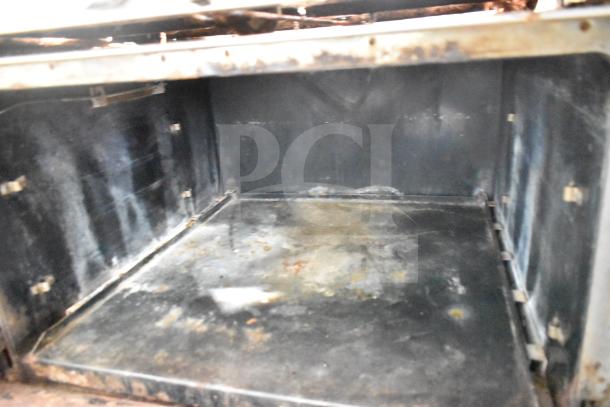 Southbend P48D-BBBB commercial gas range oven interior; visible signs of wear, suitable for heavy-duty use.