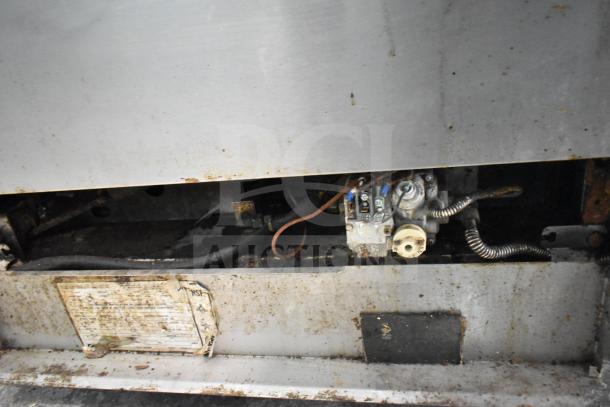 Southbend P48D-BBBB 8 burner range underside, showing gas connections and wear. Label partially visible.