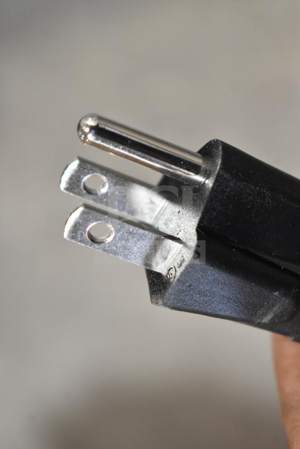Close-up of a power plug for the Hatco GRSBF-72-I built-in heated shelf warmer, 120 volts, showing prongs and black casing.