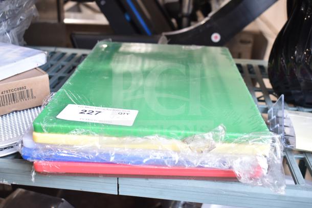 Stack of colorful cutting boards in protective wrap, displayed on a metal shelf.