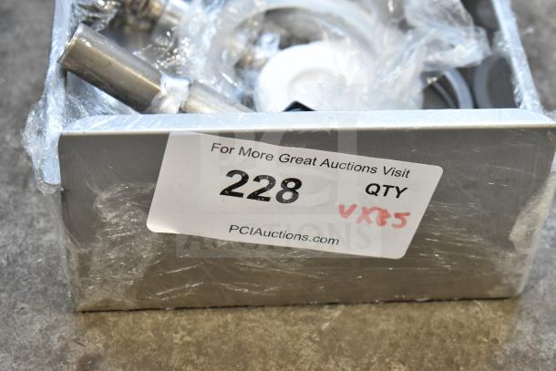 Box with assorted metal items, wrapped in plastic. Label shows "For More Great Auctions Visit," lot number 228, quantity noted.