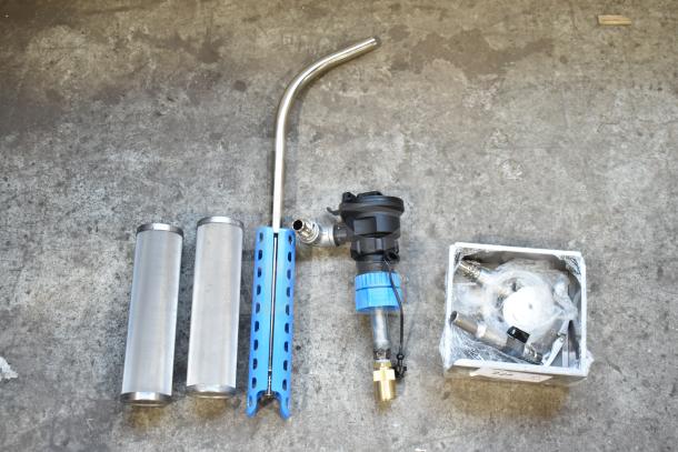 Assorted new scratch and dent equipment, includes two stainless steel cylinders, a nozzle, and various parts in a box.