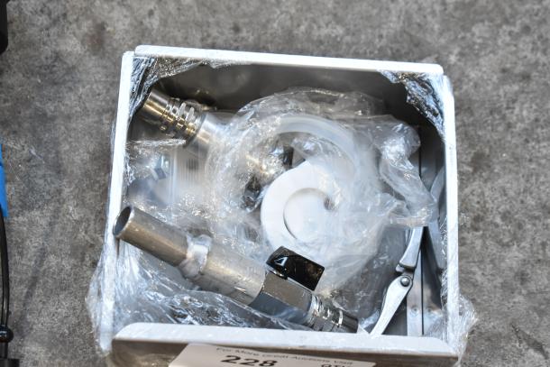 Assorted metal parts in original packaging; includes valves and fittings. Condition: new with minor scratches or dents.