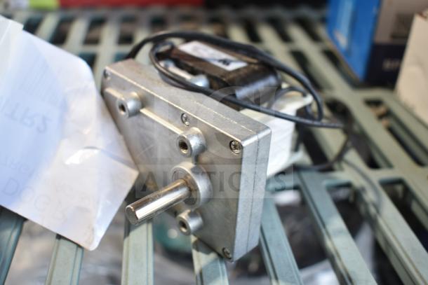 Avantco 177PRGMTR2 motor for hot dog roller grills, new condition, 120V, shown with attached wiring and mounting plate.