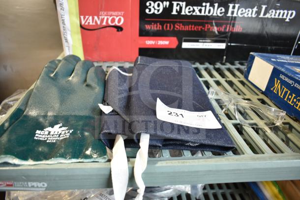 Set of brand new items including a blue apron, green MCR Safety nitrile gloves, and clear safety glasses on a shelf.
