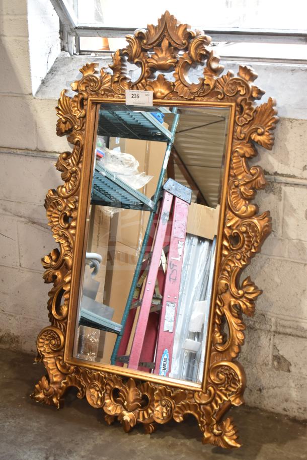 Antique-style mirror with ornate gold frame, baroque design, excellent condition, tag reads "235 QTY."