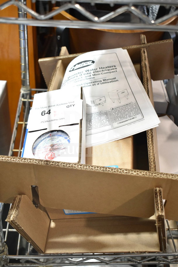 Brand new Hatco C-13 Commercial Booster Water Heater with accessories and manual in open cardboard packaging.