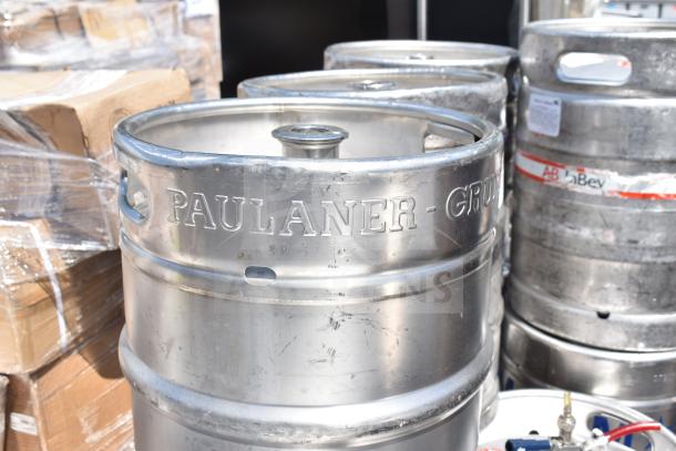 10 kegs, including half-size barrel kegs, branded "Paulaner" and "AB InBev," in used condition. Auction lot offers 10 times bid value.