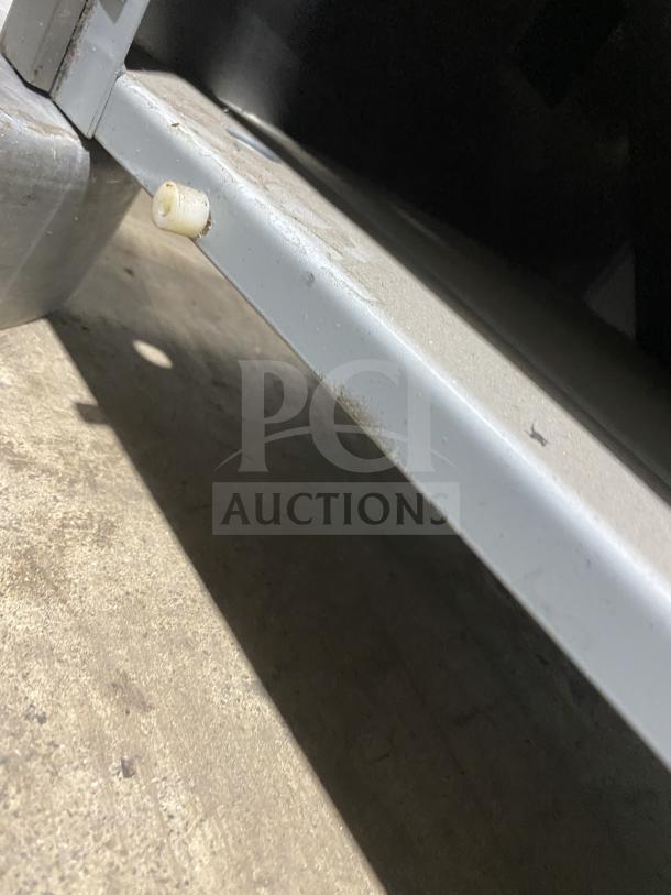 Close-up of the base or stand of a Taylor Crown C70733 soft serve machine. Visible metal frame detail.