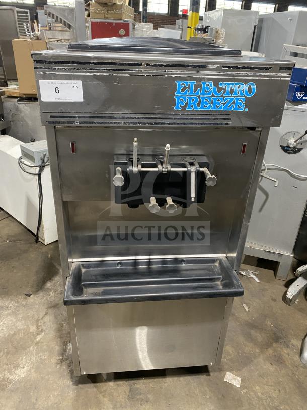 Electro Freeze stainless steel soft serve machine with twin/twist function, 2 hoppers, 3 dispensers, on casters. Fair condition.