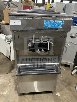 Electro Freeze stainless steel soft serve machine with twin/twist function, 2 hoppers, 3 dispensers, on casters. Fair condition.