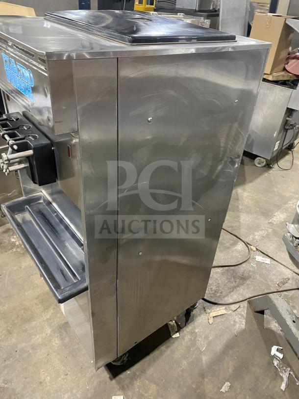 Electro Freeze stainless steel soft serve machine with twin/twist dispensers, 2 hoppers, on casters.