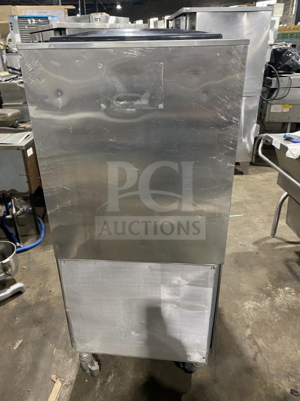 Electro Freeze stainless steel soft serve machine with 2 hoppers, 3 dispensers, on casters. Signs of wear visible.