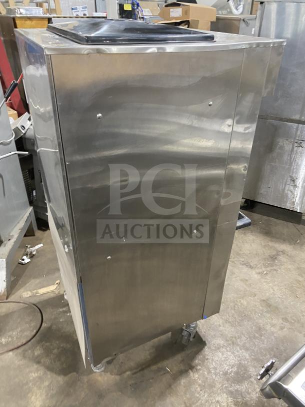 Electro Freeze stainless steel soft serve ice cream machine with 2 hoppers, 3 dispensers, on casters, excellent condition.