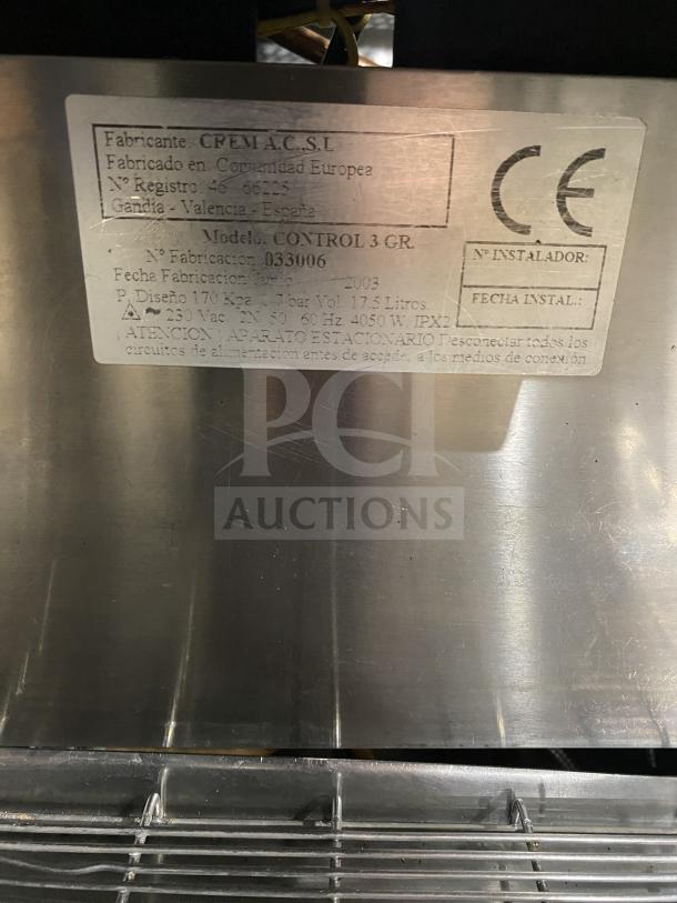 Danesi CONTROL3GR stainless steel espresso machine, 3-group, 220V, with porta filter handles; label shows model and specs.