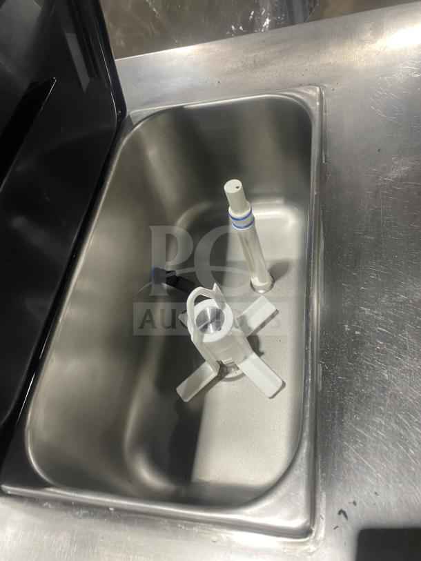 Stainless steel interior of Spaceman Model 6236C soft serve machine. Features include mixing paddles, clean condition.