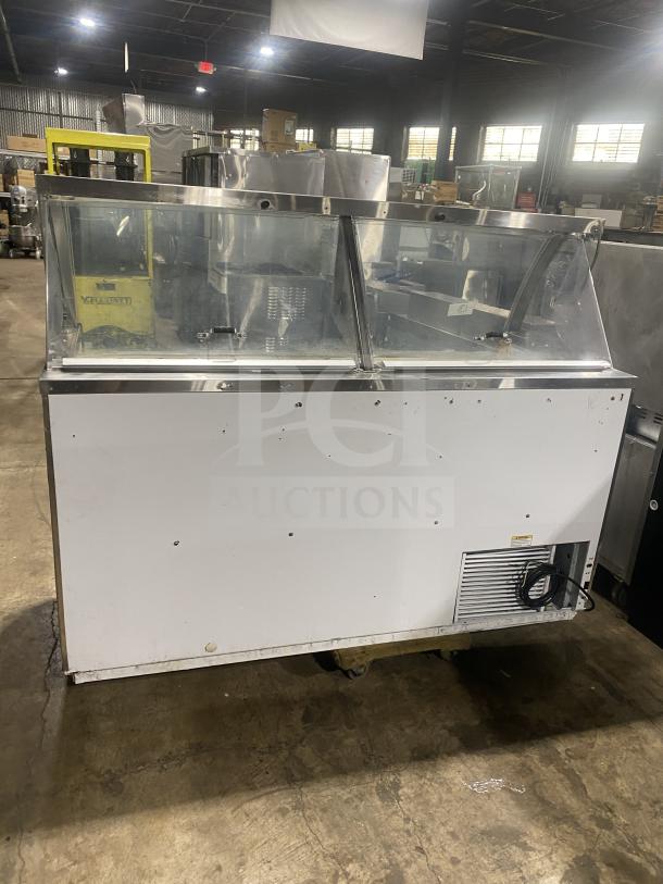 Commercial stainless steel curved glass ice cream dipping cabinet with rear lift-open access, in good condition.