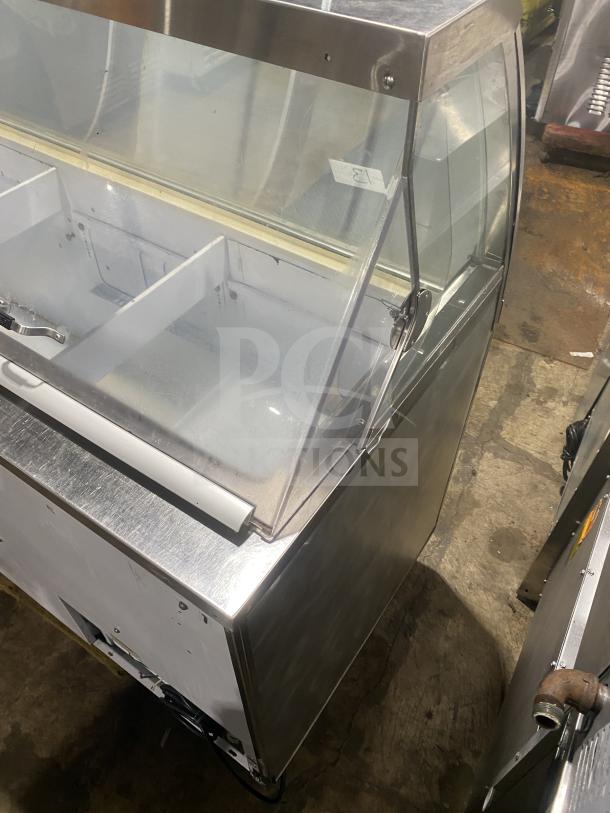 Commercial stainless steel ice cream dipping cabinet with curved glass and rear lift-open access in good condition.
